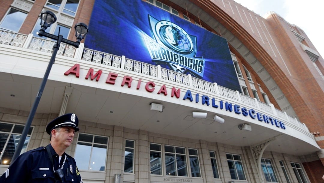 Dallas police detective Warren Breedlove stands outside American Airlines Center before an NBA basketball game between the Dallas Mavericks and the Memphis Grizzlies, Monday, April 15, 2013, in Dallas. Breedlove said that regular security officers were moved from their posts inside to keep watch outside the building following explosions at the Boston Marathon finish line on Monday.