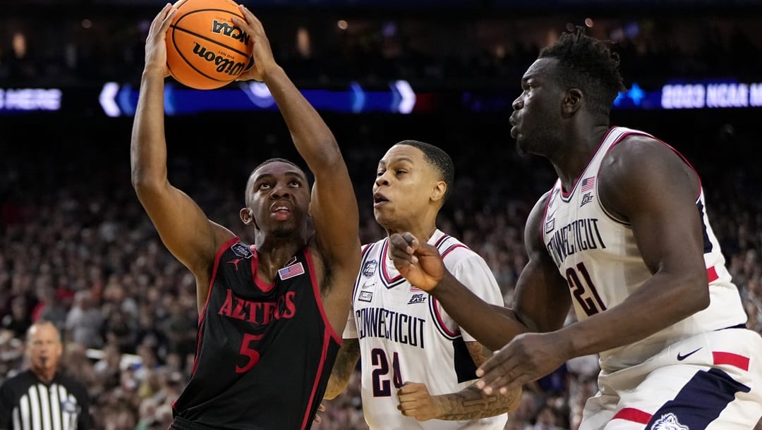 San Diego State guard Lamont Butler (5) drives as Connecticut guard Jordan Hawkins (24) defends during the second half of the men's national championship college basketball game in the NCAA Tournament on Monday, April 3, 2023, in Houston.