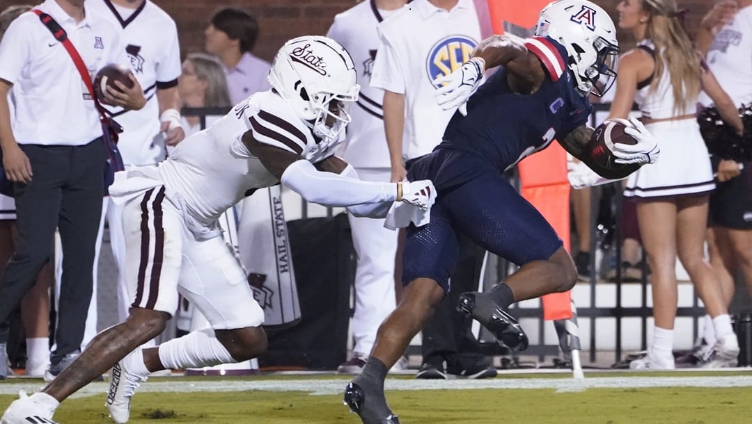 Arizona wide receiver Jacob Cowing (2) pulls away from Mississippi State cornerback Decamerion Richardson (3) for an 18-yard touchdown pass reception during the second half of an NCAA college football game Saturday, Sept. 9, 2023, in Starkville, Miss.