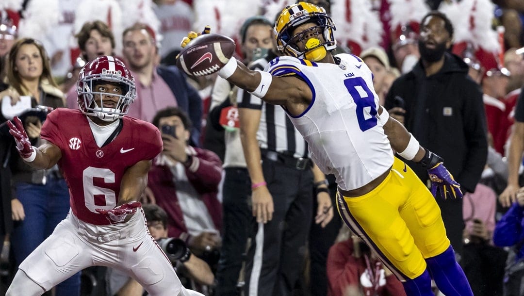 LSU safety Major Burns (8) dives for a ball intended for Alabama wide receiver Kobe Prentice (6) during the first half of an NCAA college football game, Saturday, Nov. 4, 2023, in Tuscaloosa, Ala.