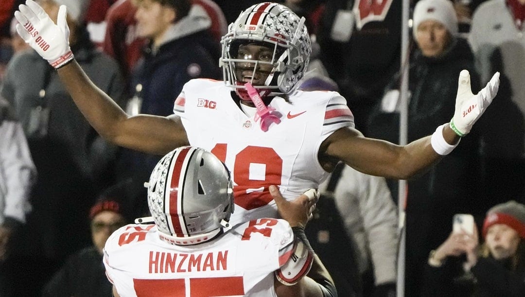 Ohio State's Marvin Harrison Jr. (18) is congratulated after his touchdown catch during the first half of an NCAA college football game against Wisconsin Saturday, Oct. 28, 2023, in Madison, Wis.