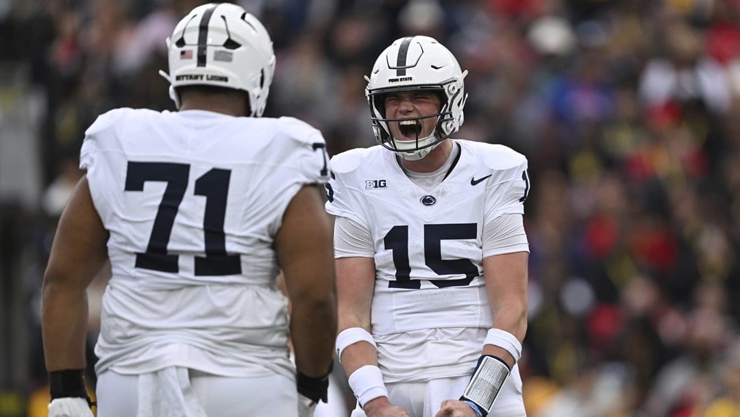 Penn State quarterback Drew Allar, right, reacts after throwing for a touchdown against Maryland during an NCAA football game on Saturday, Nov. 4, 2023, in College Park, Md.