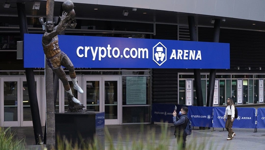 A man takes a picture of the statue of former Los Angeles Lakers player Elgin Baylor in front of crypto.com Arena prior to an NBA basketball game between the Los Angeles Lakers and the Portland Trail Blazers Wednesday, Nov. 30, 2022, in Los Angeles.