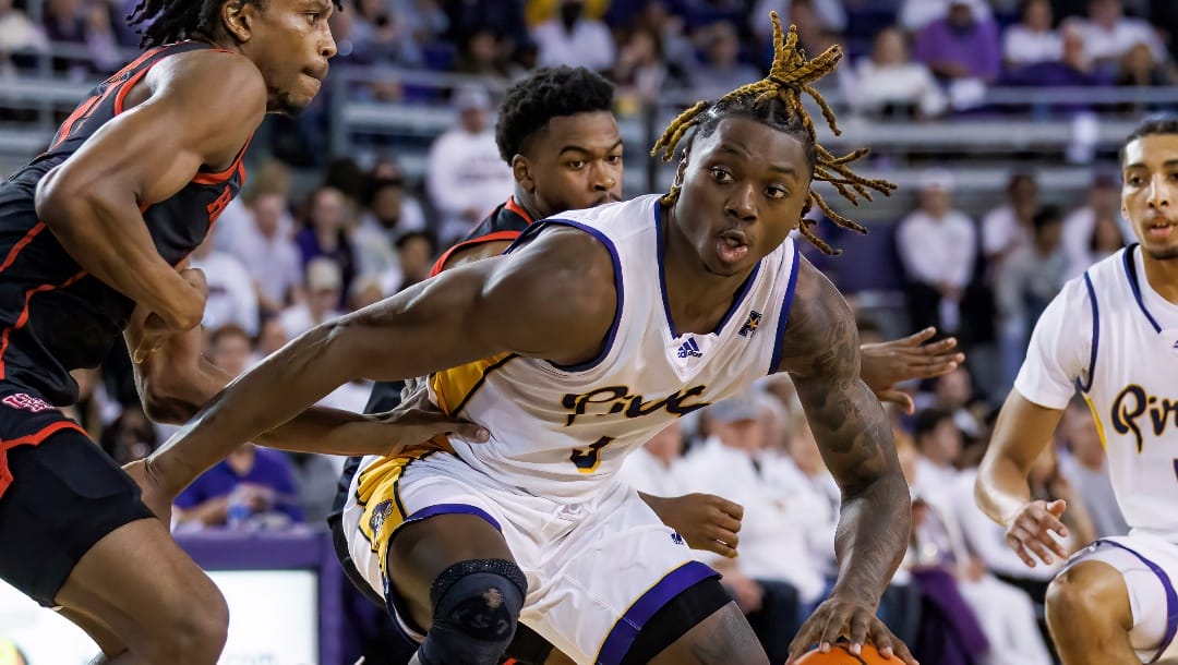 East Carolina's RJ Felton (3) is defended by Houston's Tramon Mark, left, during the second half of an NCAA college basketball game in Greenville, N.C., Saturday, Feb. 25, 2023. (AP Photo/Ben McKeown)