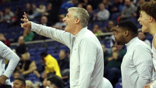 Marist Red Foxes' head coach John Dunne gives instructions from the side line during an NCAA basketball game between Maine Black Bears and Marist Red Foxes at the O2 Arena, in London, Sunday, Dec.4, 2022.