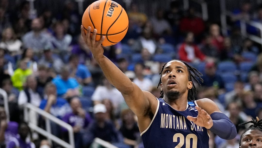 Montana State guard Robert Ford III (20) goes past Kansas State guard Cam Carter (5) to score during the first half of a first-round college basketball game in the NCAA Tournament on Friday, March 17, 2023, in Greensboro, N.C. (AP Photo/John Bazemore)