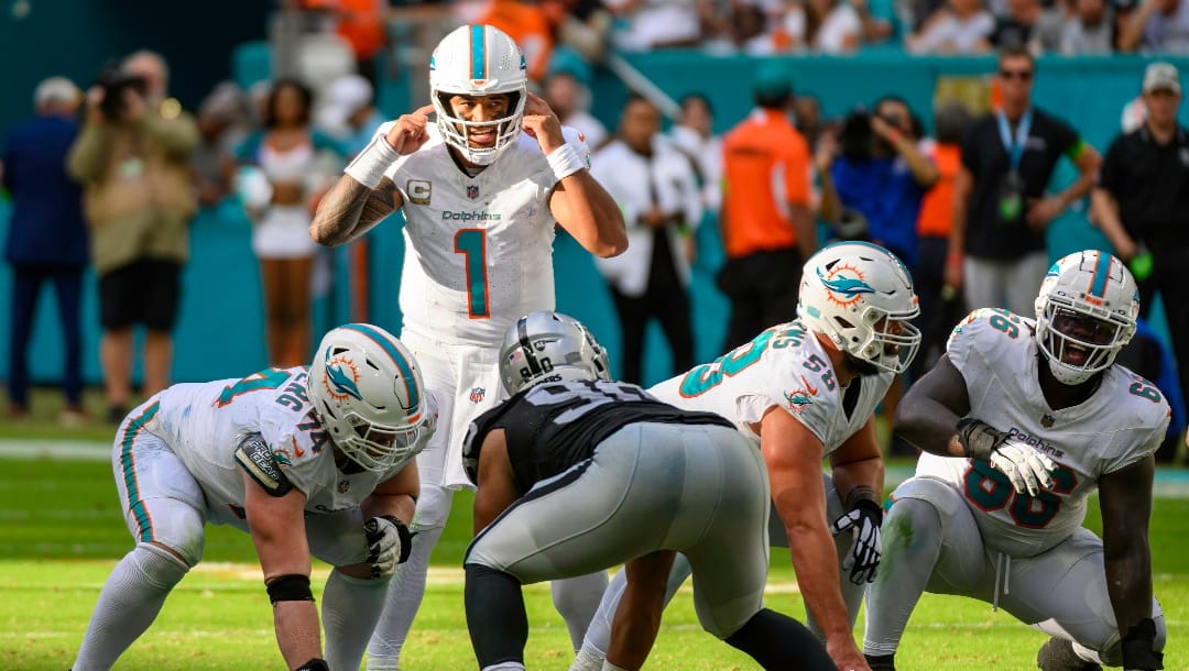 Miami Dolphins quarterback Tua Tagovailoa (1) gestures as he calls a play at the line of scrimmage during an NFL football game against the Las Vegas Raiders, Sunday, Nov. 19, 2023, in Miami Gardens, Fla. (AP Photo/Doug Murray)