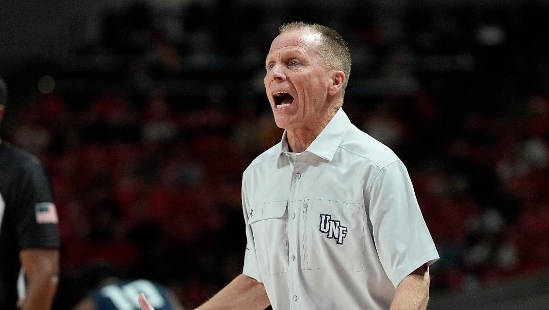 North Florida head coach Matthew Driscoll reacts to a call during the first half of an NCAA college basketball game against Houston, Tuesday, Dec. 6, 2022, in Houston. (AP Photo/Kevin M. Cox),