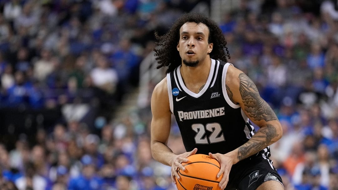 Providence guard Devin Carter (22) looks for an open man during the second half of a first-round college basketball game against Kentucky in the NCAA Tournament on Friday, March 17, 2023, in Greensboro, N.C. (AP Photo/John Bazemore)
