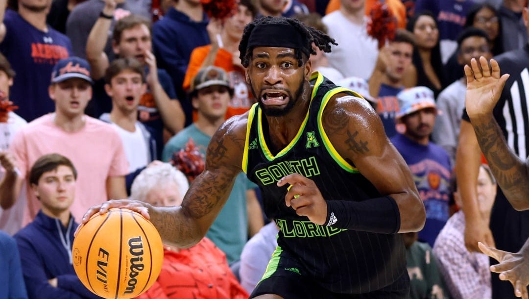 South Florida guard Selton Miguel, left, drives around Auburn guard Zep Jasper during the first half of an NCAA college basketball game Friday, Nov. 11, 2022, in Auburn, Ala. (AP Photo/Butch Dill)