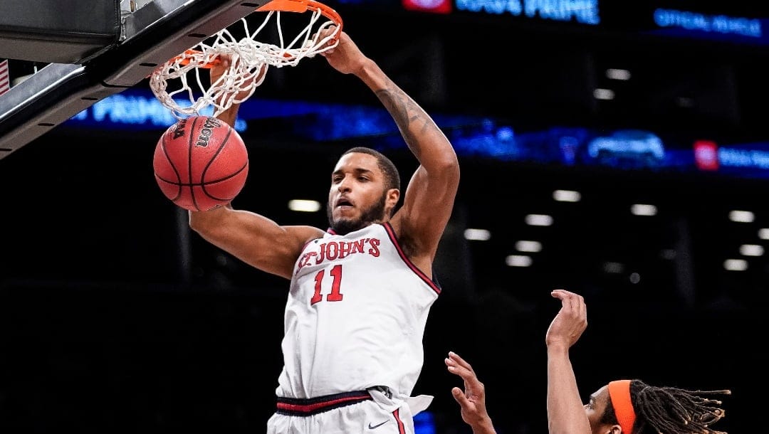 St. John's Joel Soriano (11) dunks in the second half of an NCAA college basketball championship game against Syracuse at the Good Samaritan Empire Classic, Tuesday, Nov. 22, 2022, in New York. (AP Photo/John Minchillo)