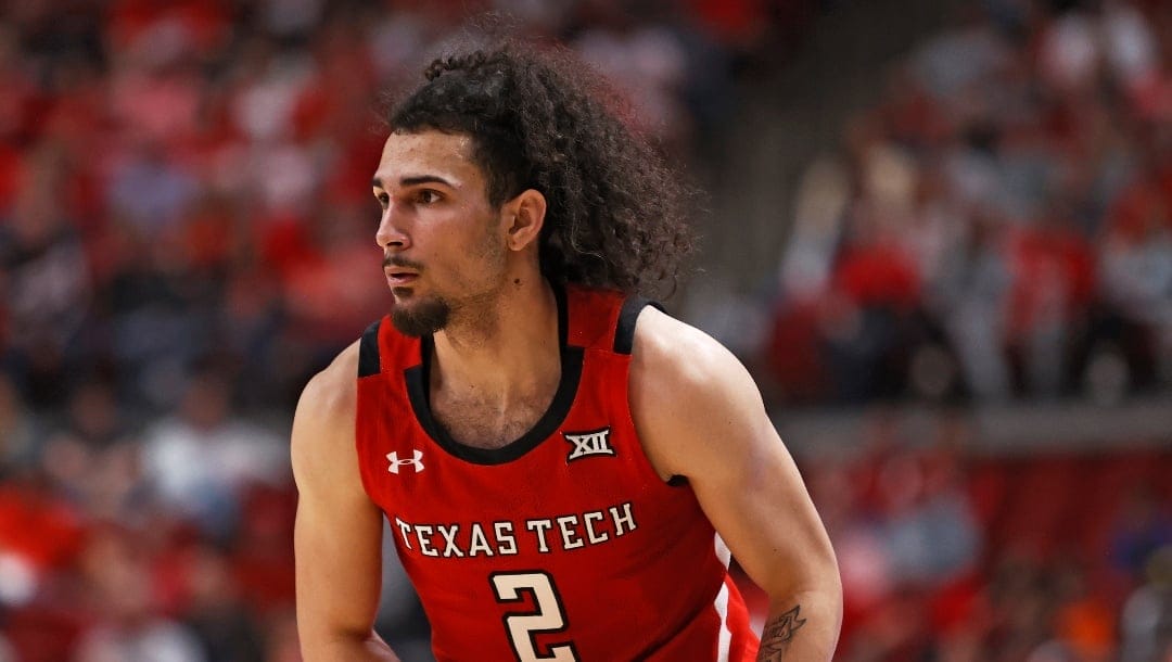 Texas Tech's Pop Isaacs (2) looks to pass the ball during the first half of an NCAA college basketball game against Oklahoma State, Saturday, March 4, 2023, in Lubbock, Texas. (AP Photo/Brad Tollefson)
