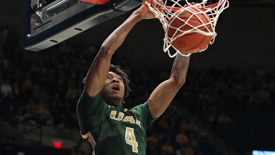 UAB guard Eric Gaines dunks against West Virginia during the first half of an NCAA college basketball game in Morgantown, W.Va., Saturday, Dec. 10, 2022.
