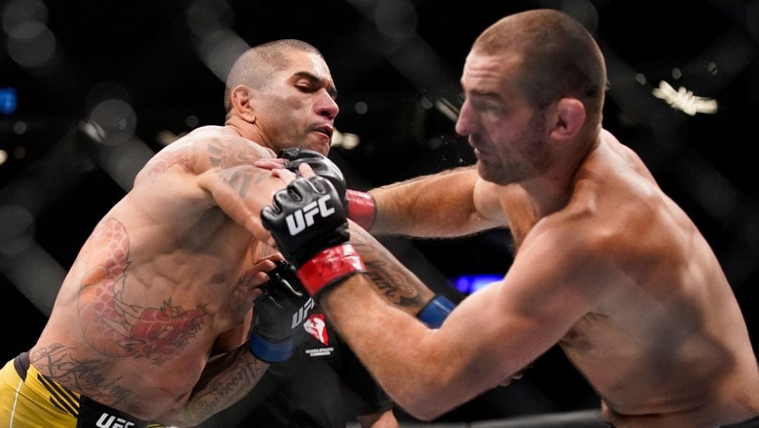 Alex Pereira, left, fights Sean Strickland in a middleweight bout during the UFC 276 mixed martial arts event.