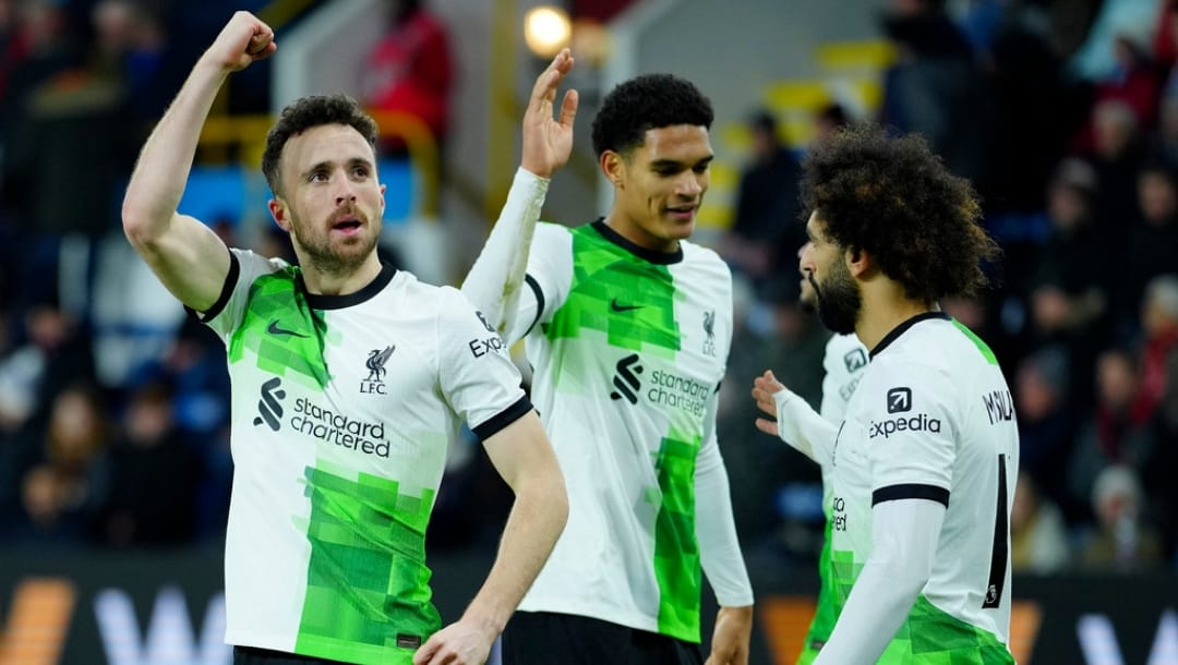 Liverpool's Diogo Jota, left, celebrates scoring his sides second goal during the English Premier League soccer match between Burnley and Liverpool at Turf Moor stadium in Burnley, England, Tuesday, Dec. 26, 2023.
