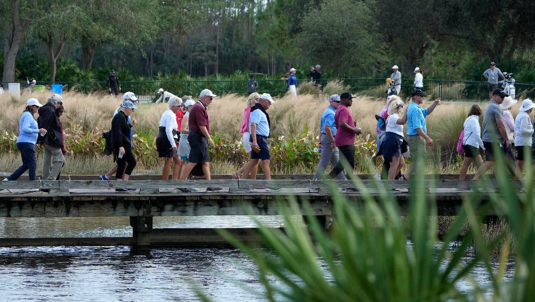 Fans walk on a bridge during the second round of the LPGA CME Group Tour Championship golf tournament, Friday, Nov. 18, 2022, at the Tiburón Golf Club in Naples, Fla.