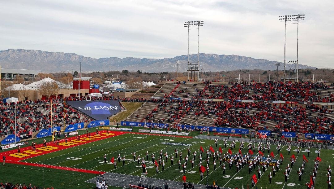 The UNM Marching Band performs in the University Stadium, backdropped by the Sandia Mountains, before the start of the New Mexico Bowl NCAA college football game between New Mexico and Arizona in Albuquerque, N.M., Saturday, Dec. 19, 2015.