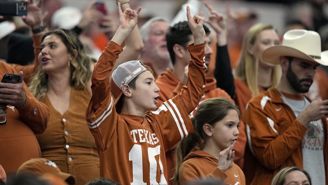 Texas fans cheer during the Big 12 Conference championship NCAA college football game aginst Oklahoma State in Arlington, Texas, Saturday, Dec. 2, 2023.