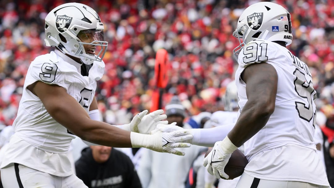 Las Vegas Raiders defensive end Tyree Wilson (9) congratulate Raiders defensive tackle Bilal Nichols (91) after he recovered a Kansas City Chiefs fumble and took it in for a touchdown during the first half of an NFL football game, Monday, Dec. 25, 2023 in Kansas City, Mo.