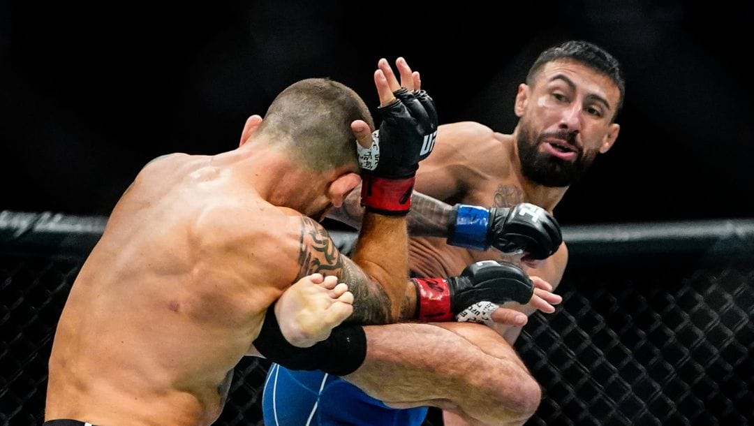 Chris Gutierrez, right, kicks Frankie Edgar during the first round of a bantamweight bout at the UFC 281 mixed martial arts event.