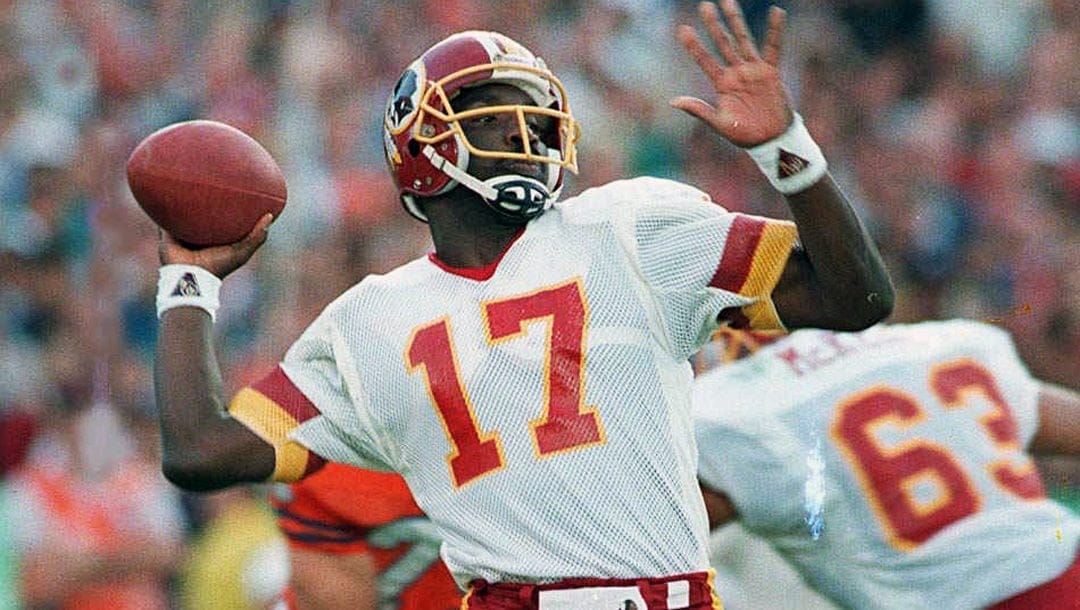 In this Jan. 31, 1988, file photo, Washington Redskins quarterback Doug Williams prepares to let go of a pass during first quarter of Super Bowl XXII against the Denver Broncos in San Diego.