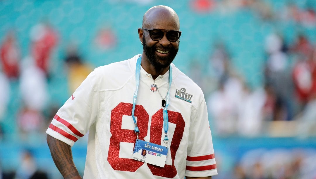 Former NFL player Jerry Rice walks on the field before the NFL Super Bowl 54 football game between the San Francisco 49ers and Kansas City Chiefs, Sunday, Feb. 2, 2020, in Miami Gardens, Fla.