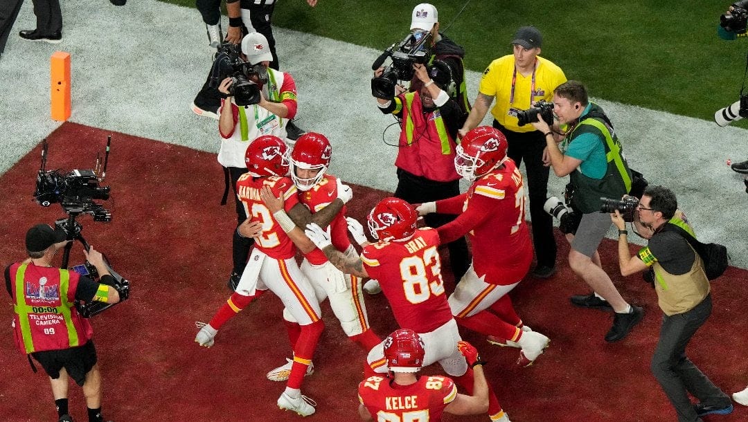 Kansas City Chiefs quarterback Patrick Mahomes, center, celebrates with wide receiver Mecole Hardman Jr. (12) after throwing the game-wining touchdown during overtime of the NFL Super Bowl 58 football game against the San Francisco 49ers Sunday, Feb. 11, 2024, in Las Vegas.