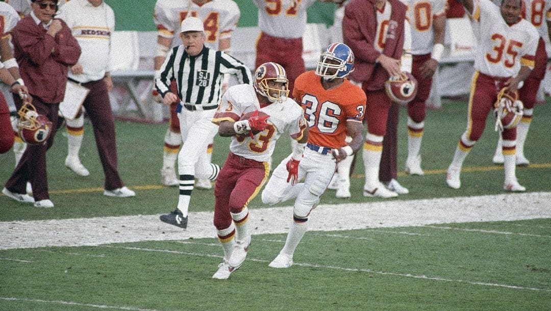 Washington Redskins wide receiver Ricky Sanders (83) is followed by Denver Broncos cornerback mark Haynes (36) as he goes into the endzone for a touchdown in the 2nd quarter of Super Bowl XXII, Sunday, Jan. 31, 1988 in San Diego.