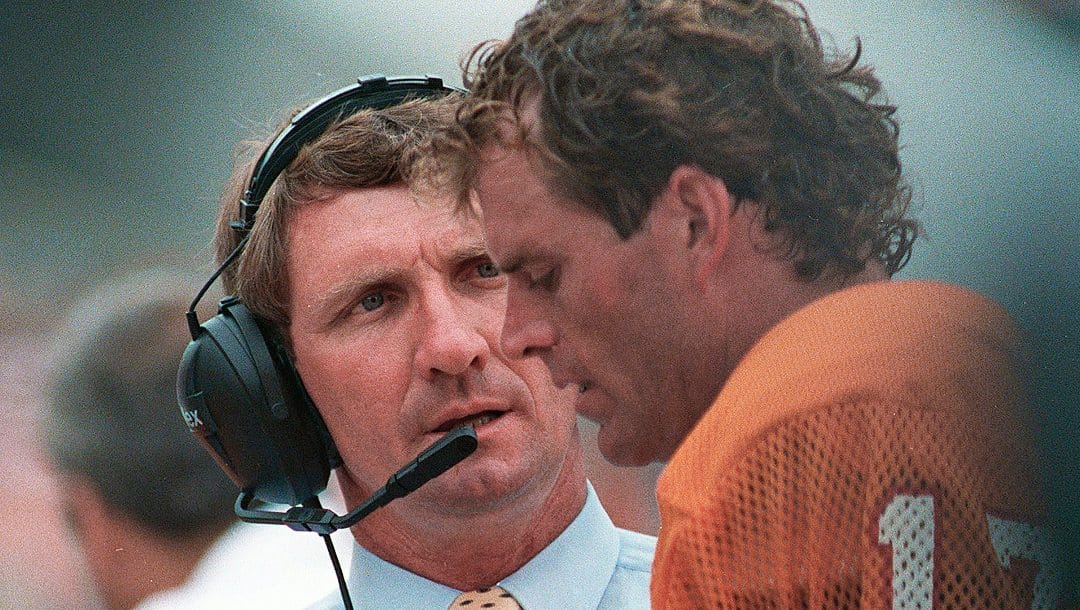 In this Sept.13,1987 file photo, Former Alabama coach Ray Perkins, now with the Tampa Bay Buccaneers, talks with quarterback Steve DeBerg on the sidelines during an NFL regular season opener against the Atlanta Falcons in Tampa, Fla. Perkins led the New York Giants from 1979 to 1982, the Alabama Crimson Tide from 1983 to '86 and the Tampa Bay Buccaneers from 1987 to 1990. Perkins coaches football at tiny Jones County Junior College, in Mississippi.
