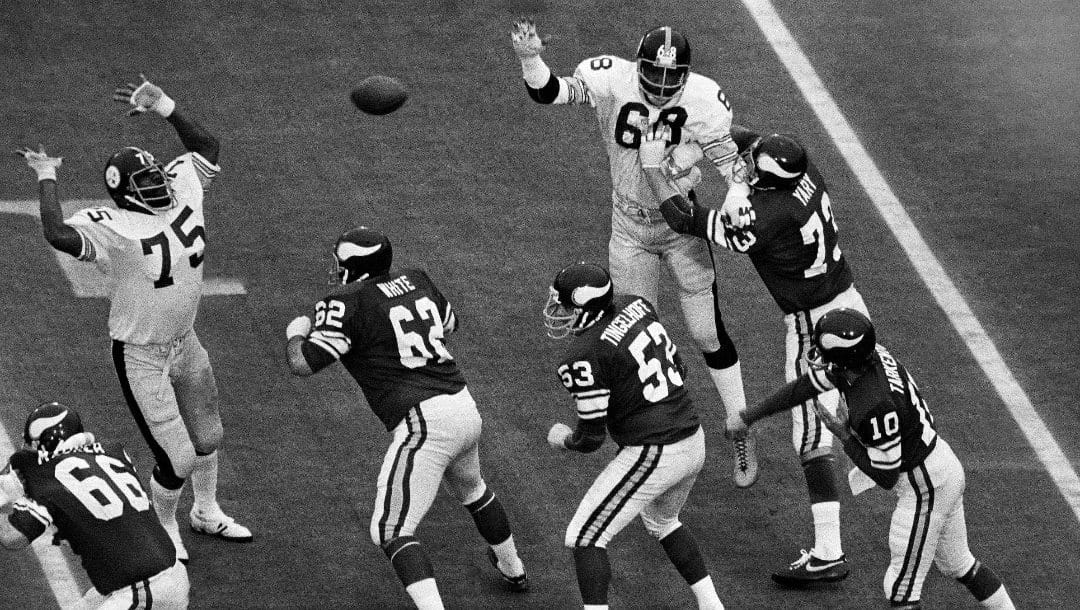 In this Jan. 12, 1975, file photo, Pittsburgh Steelers tackle Joe Greene (75) defends a pass as Minnesota Viking players Andy Maurer (66), Ed White (62), Mick Tingelhoff (53) and Ron Yary (73) protect quarterback Fran Tarkenton (10) during NFL football's Super Bowl IX at Tulane Stadium New Orleans, La.