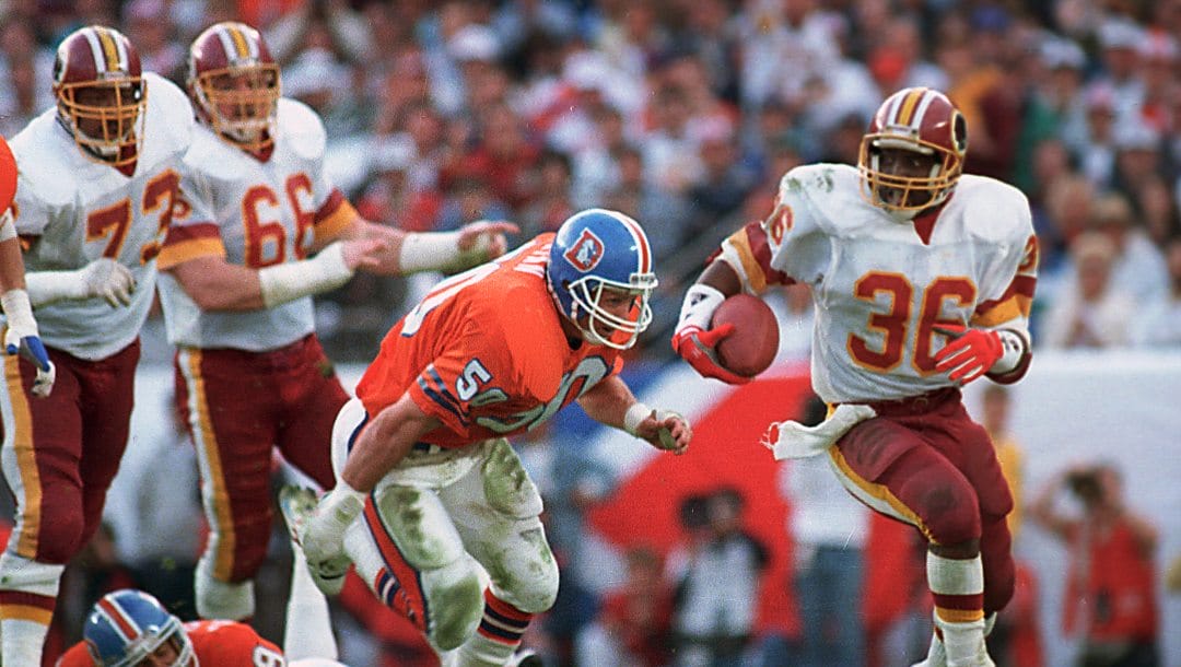 In this Jan. 31, 1988, file photo, Washington Redskins running back Timmy Smith (36) goes around Denver Broncos linebacker Jim Ryan (50) on a long run during NFL football's Super Bowl XXII in San Diego.