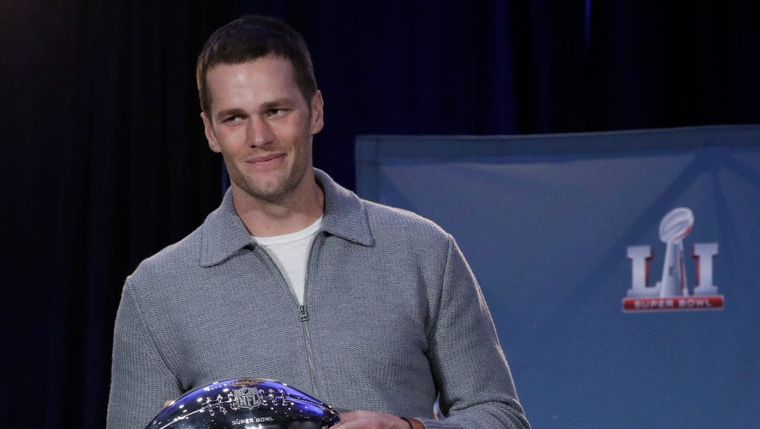 In this Feb. 6, 2007, file photo, New England Patriots quarterback Tom Brady poses with his MVP trophy during a news conference after the NFL Super Bowl 51 football game in Houston.