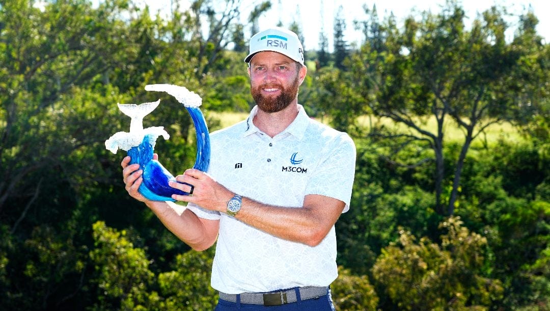 Chris Kirk holds the champions trophy after the final round of The Sentry golf event, Sunday, Jan. 7, 2024, at Kapalua Plantation Course in Kapalua, Hawaii.