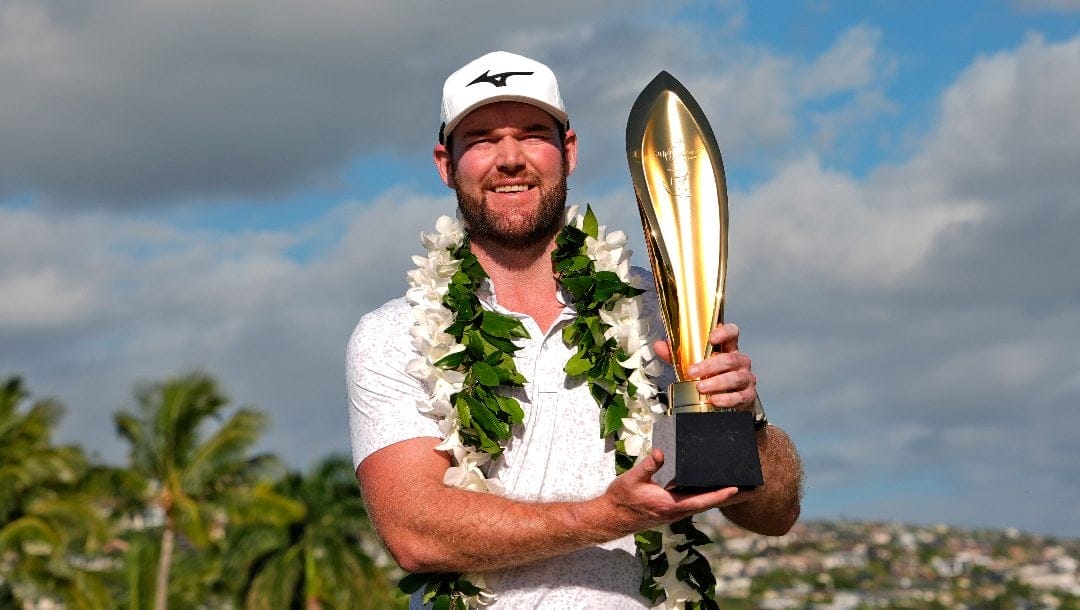 Grayson Murray holds the trophy after winning the Sony Open golf event, Sunday, Jan. 14, 2024, at Waialae Country Club in Honolulu.