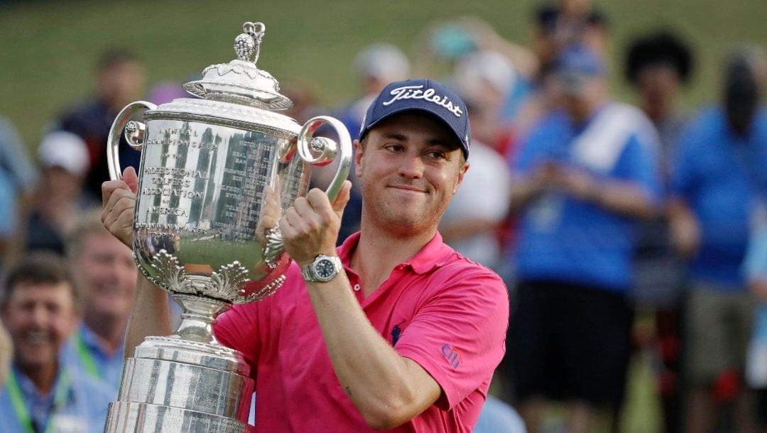 Justin Thomas poses with the Wanamaker Trophy after winning the PGA Championship golf tournament at the Quail Hollow Club Sunday, Aug. 13, 2017, in Charlotte, N.C.