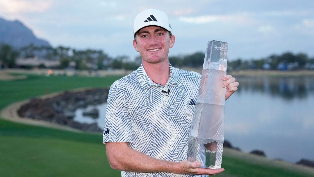 Nick Dunlap holds the trophy after winning the American Express golf tournament, Sunday, Jan. 21, 2024, in La Quinta, Calif.