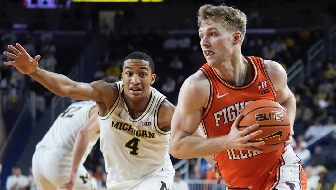 Illinois forward Marcus Domask (3) drives on Michigan guard Nimari Burnett (4) in the first half of an NCAA college basketball game in Ann Arbor, Mich., Thursday, Jan. 18, 2024.