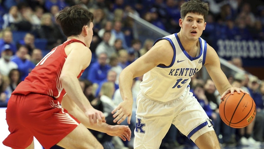 Kentucky's Reed Sheppard, right, drives while defended by Illinois State's Johnny Kinziger, left, during the second half of an NCAA college basketball game in Lexington, Ky., Friday, Dec. 29, 2023.