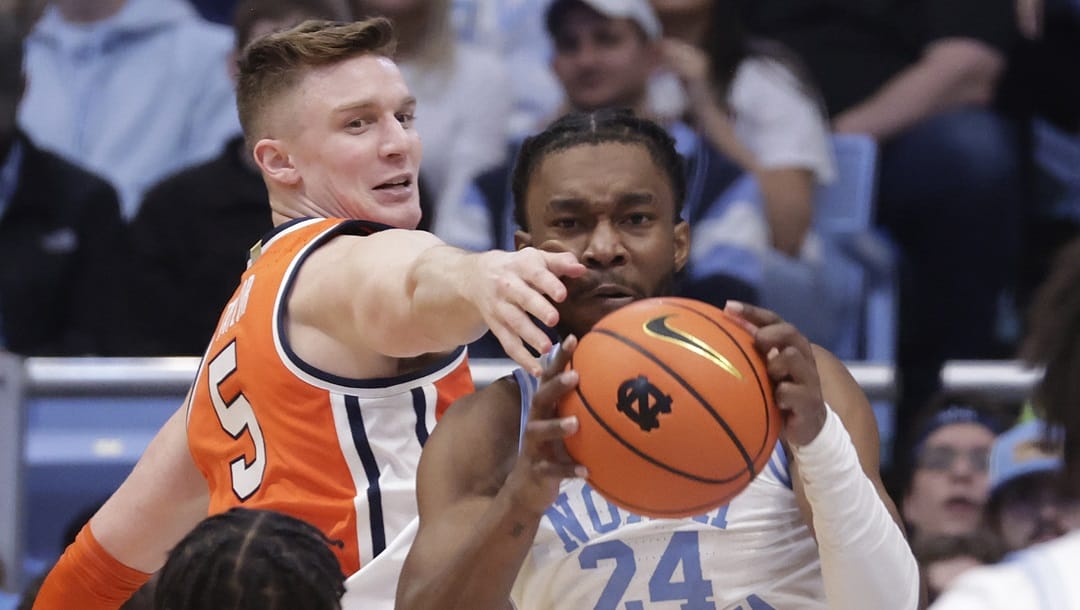 North Carolina forward Jae'Lyn Withers (24) grabs a rebound against Syracuse guard Justin Taylor (5) during the second half of an NCAA college basketball game Saturday, Jan. 13, 2024, in Chapel Hill, N.C.