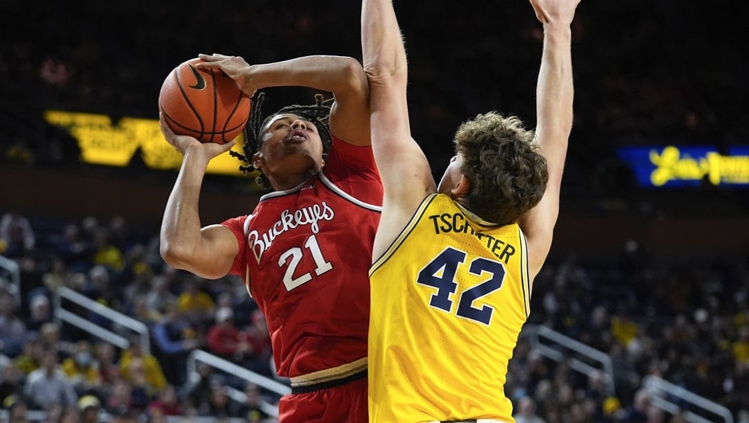 Ohio State forward Devin Royal (21) shoots on Michigan forward Will Tschetter (42) in the first half of an NCAA college basketball game in Ann Arbor, Mich., Monday, Jan. 15, 2024.