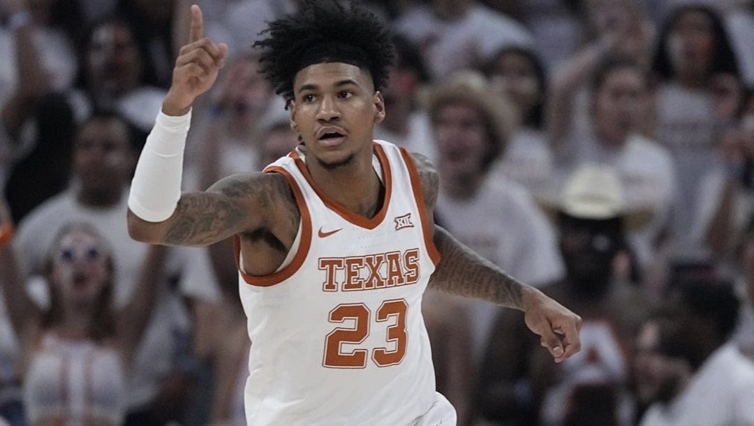 Texas forward Dillon Mitchell celebrates after a score against Houston during the first half of an NCAA college basketball game in Austin, Texas, Monday, Jan. 29, 2024.