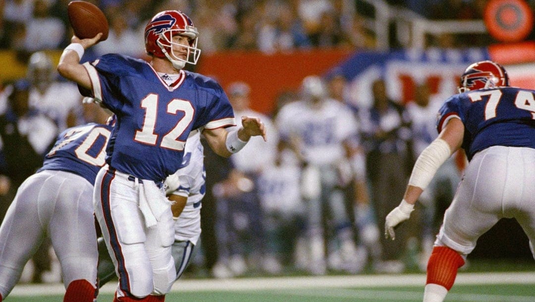 Buffalo Bills quarterback Jim Kelly (12) looks for an open receiver first quarter action against the Dallas Cowboys at Super Bowl XXVIII in the Georgia Dome, Sunday, Jan. 30, 1994. The Cowboys defeated the Bills 30-13.