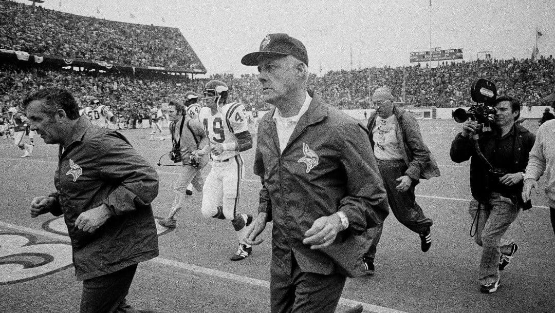 Minnesota Vikings head coach Bud Grant, foreground, and his staff run off the field at Rice Stadium in Houston following the Jan. 14, 1974, NFL football Super Bowl game against the Miami Dolphins.
