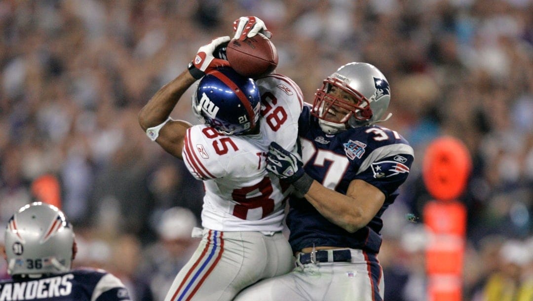 FILE - In this Feb. 3, 2008, file photo, New York Giants receiver David Tyree (85) catches a 32-yard pass in the clutches of New England Patriots safety Rodney Harrison (37) during the fourth quarter of NFL football's Super Bowl XLII in Glendale, Ariz. The Giants won 17-14.