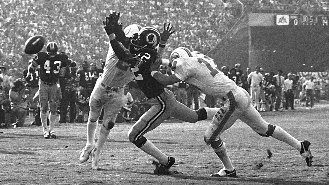 Miami Dolphins' Lloyd Mumphord, left, and Jake Scott (13) break up a pass to Washington Redskins' Charley Taylor near the goal line to stop a Redskin drive in the third quarter of the Super Bowl game in Los Angeles, Jan. 14, 1973. (AP Photo)