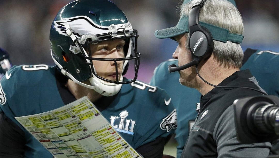 In this Feb. 4, 2018, file photo, Philadelphia Eagles head coach Doug Pederson, right, talks to Nick Foles during the first half of the NFL Super Bowl 52 football game against the New England Patriots, in Minneapolis. Facing the mighty New England Patriots on the NFL's biggest stage, Philadelphia Eagles coach Doug Pederson's decision to try a trick play _ the "Philly Special" _ on a fourth down late in the first half of Super Bowl 52 will be remembered as one of the gutsiest calls in sports history. That signature moment between Foles and Pederson standing on the sideline discussing the play was turned into a bronze statue that sits outside the team's stadium as a reminder of the greatest play in franchise history.