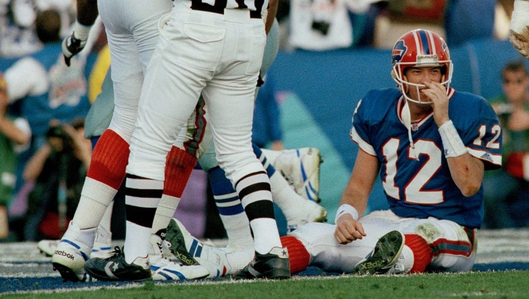 FILE - Buffalo Bills quarterback Jim Kelly (12) sits on the field after fumbling the ball in the first quarter and giving up a touchdown to Dallas Cowboys defender Jimmie Jones during NFL football's Super Bowl XXVII in Pasadena, Calif., Jan. 31, 1993. Cowboys defender Charles Haley forced the fumble that Jones took in for the score. (AP Photo/Eric Risberg, File)