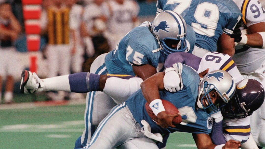 Detroit Lions quarterback Rodney Peets (9) is tackled for a loss by Minnesota Vikings Chris Doleman (56) in the third quarter, Sunday, Dec. 5, 1993, in Pontiac, Mich. Peets was sacked seven times in the game, while throwing for four interceptions, in the 13-0 loss to the Vikings.