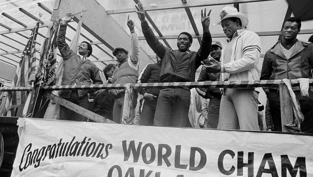 Members of the Oakland Raiders defense respond to fans during a Super Bowl parade and celebration in Oakland, Calif., Jan. 27, 1981. From left, cornerback Dwayne O'Steen, safety Mike Davis, linebacker Rod Martin, guard and team captain Gene Upshaw, and end Willie Jones.