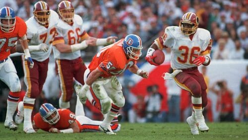 In this Jan. 31, 1988, file photo, Washington Redskins running back Timmy Smith (36) goes around Denver Broncos linebacker Jim Ryan (50) on a long run in the first quarter of NFL football's Super Bowl XXII in San Diego. Smith ran for a record 204 yards against the Broncos in the game.